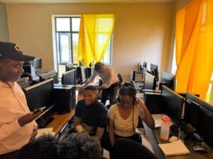 Students working in a computer lab with yellow curtains