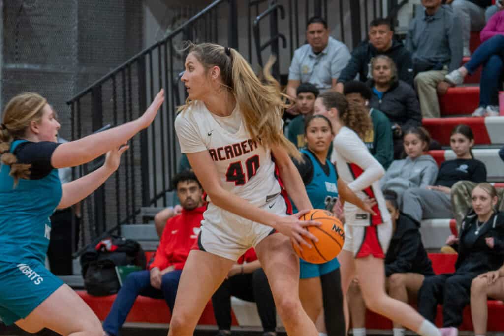 Albuquerque Academy female basketball player in action during game.