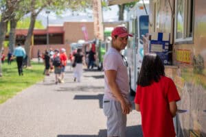 Father and daughter order at food truck